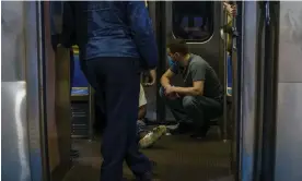  ?? Photograph: Chicago Tribune/TNS ?? A rider recovers after being given naloxone after he was found unresponsi­ve from an overdose on a train at the Forest Park station on in 2022.