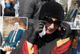  ?? (Mohamed Abd El Ghany/Reuters) ?? A MUBARAK supporter mourns near the main gate of a cemetery during the leader’s burial ceremony, east of Cairo on February 26.