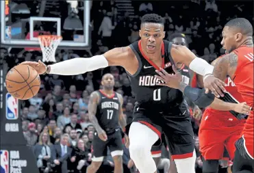  ?? AP FILE ?? Houston Rockets guard Russell Westbrook, left, said Monday that he has tested positive for coronaviru­s, and that he plans to eventually join his team at the restart of the NBA season.