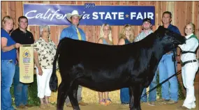  ?? SUBMITTED PHOTO ?? Brittany Heffner, right, poses with her family and her heifer after winning top honors at the California State Fair in Sacramento in July.