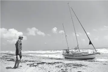  ?? AMY BETH BENNETT/SOUTH FLORIDA SUN SENTINEL ?? James Mitchell Trice looks out at his beached 41-foot sailboat on Highland Beach on Monday.