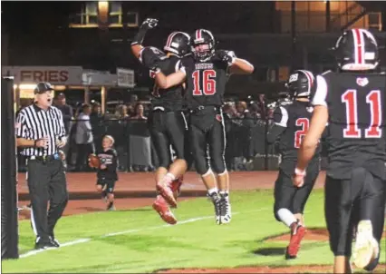  ?? AUSTIN HERTZOG - DIGITAL FIRST MEDIA ?? Boyertown’s Nicholas Moccia (16) and Jamison Moccia (7) celebrate after Jamison’s touchdown in the second quarter against Perkiomen Valley last week. The Bears topped Owen J. Roberts 24-21 on a last-minute field goal by Declan Coyle, below, on Oct. 6.