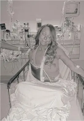  ??  ?? Mariah Carey is treated at a hospital in a photo she tweeted Tuesday after dislocatin­g her shoulder during a music video shoot.