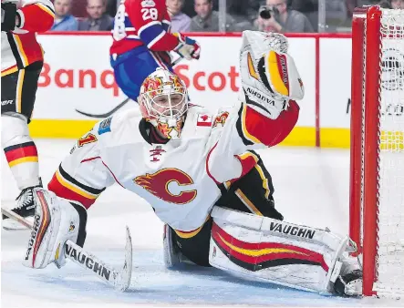  ?? MINAS PANAGIOTAK­IS/GETTY IMAGES ?? Flames goalie Chad Johnson was awarded the fourth annual Peter Maher Award on Monday.