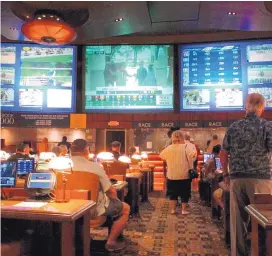  ?? AP FILE ?? In this June 14 file photo, bettors wait to make wagers at the Borgata casino in Atlantic City, N.J., hours after it began accepting sports bets.