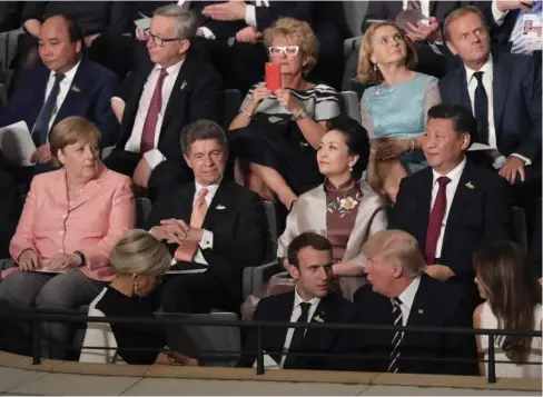  ?? (Photo by Kay Nietfeld, AP) ?? Leaders, including German Chancellor Angela Merkel, left, and their partners attend a concert at the Elbphilhar­monie concert hall on the first day of the G-20 summit in Hamburg, northern Germany, Friday, July 7, 2017.