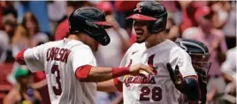  ?? JEFF ROBERSON/ASSOCIATED PRESS ?? Nolan Arenado (right) knocked in four runs during the Cardinals’ win Sunday.