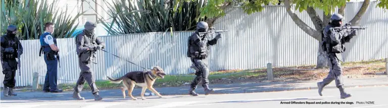  ?? Photo / NZME ?? Armed Offenders Squad and police during the siege.