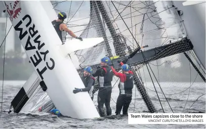  ?? VINCENT CURUTCHET/LLOYD IMAGES ?? Team Wales capsizes close to the shore