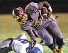  ?? STAFF PHOTO BY ROBIN RUDD ?? Tyner’s Tyon Young tries to remain on his feet after being hit by Bledsoe’s Colby Rogers during Friday night’s game. Young had a 1-yard touchdown run in the third quarter.