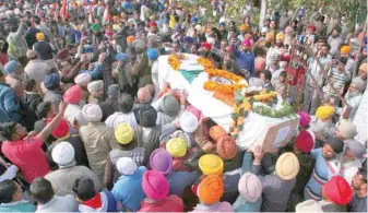  ?? —- Reuters ?? People carry a coffin containing the remains of Sukhjinder Singh, a Central Reserve Police Force (CRPF) personnel, before his cremation in Gandiwind village, Amritsar, on Saturday.