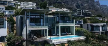  ?? ?? This three-bedroom, two-bathroom property designed by architect Pedro Roos sold for R23m in September through Pam Golding Properties. Situated above the bay, it offers expansive views of the sea, beach, Twelve Apostles mountain range and Lion’s Head. It features triple volume spaces, a water feature and an Italian kitchen.