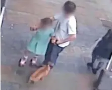  ??  ?? Horrifying: A man ushers a little girl away to safety