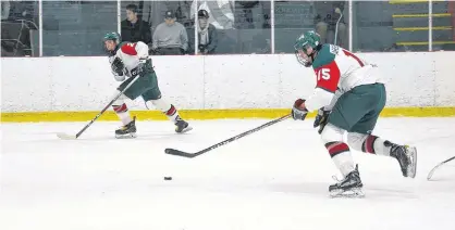  ?? JASON SIMMONDS/JOURNAL PIONEER ?? Austin Arsenault, 15, carries the puck while his linemate and brother, Donovan, 25, awaits a pass during a recent New Brunswick/P.E.I. Major Midget Hockey League game at Credit Union Centre in Kensington.