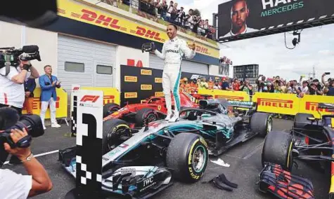  ?? AP ?? Mercedes’ Lewis Hamilton celebrates while standing on his car after winning the French Grand Prix at the Paul Ricard racetrack in Le Castellet, southern France, yesterday.