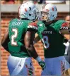  ?? GETTY IMAGES ?? Braxton Berrios (celebratin­g a TD with Joseph Yearby in 2016) told WQAM that coach Mark Richt has changed “the culture of the team.”