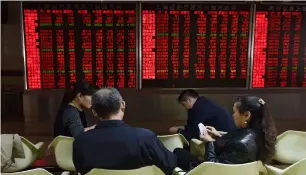  ?? — AFP ?? The Shanghai Composite index jumped 4.1 per cent to 2,654.88 on Monday.