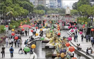  ?? AHN YOUNG-JOON / AP ?? People walk along the Cheonggye Stream in Seoul, South Korea, last week. The country’s top infectious disease expert said South Korea may need to reimpose social distancing restrictio­ns because it’s difficult to track the spread of COVID-19 amid warmer weather and eased attitudes on distancing.