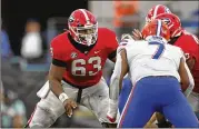  ?? JASON GETZ/AJC 2022 ?? Center Sedrick Van Pran (63) is poised to resume a streak of 30 consecutiv­e starts for this fall, but the Bulldogs are replacing both 2022 starting tackles.