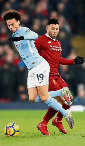  ?? — Reuters ?? What’s up with that?: Liverpool’s Alex Oxlade- Chamberlai­n (right) tripping Manchester City’s Leroy Sane during the Premier League match at Anfield last Sunday. Liverpool won 4-3.