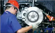  ?? BLOOMBERG ?? An employee installs brake pads on a BYD vehicle at the firm’s assembly plant in Shenzhen, Guangdong province.