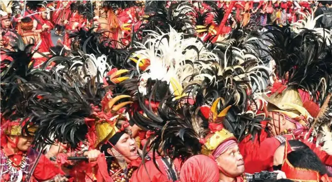  ??  ?? Indonesian dancers perform with masks of Cirebon during a flashmob entitled “Tunjukkan Indonesiam­u” or “Show your Indonesia” in Jakarta yesterday. — AFP