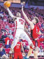  ?? Las Vegas Review-journal L.E. Baskow ?? Rebels guard Keshon Gilbert scores against Incarnate Word guard Niki Krause.