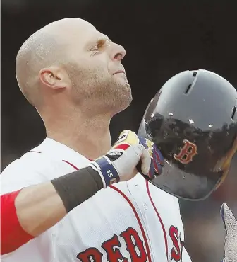  ?? AP PHOTO ?? HURTING: Dustin Pedroia is headed back to Boston after spraining his left wrist in the first inning of the Red Sox’ loss in Chicago yesterday.