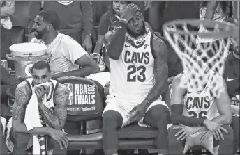  ?? AP PHOTO ?? Cleveland Cavaliers forward LeBron James (23) sits on the bench between guard George Hill, left, and guard Kyle Korver during the second half of Game 2 of basketball’s NBA Finals against the Golden State Warriors in Oakland on Sunday. The Warriors won...