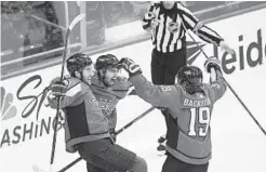  ?? NICK WASS/ASSOCIATED PRESS ?? Capitals defenseman Matt Niskanen, center, celebrates his goal with right wing Tom Wilson, left, and center Nicklas Backstrom.