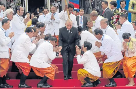  ?? AFP ?? Cambodian King Norodom Sihamoni greets new parliament­arians at the National Assembly building in Phnom Penh yesterday.