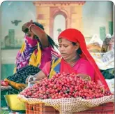  ?? PTI ?? A fruit vendor, not wearing a mask, sells cherries at a stall in New Delhi, on Tuesday
