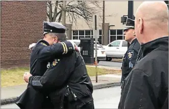  ?? PHOTO BY DANIELLE EPTING, FOR DIGITAL FIRST MEDIA ?? Retiring Assistant Chief George VanBramer hugs a fellow officer.