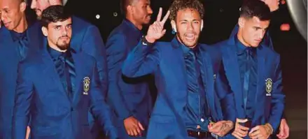  ??  ?? (From left) Brazil's Fagner, Neymar and Philippe Coutinho and the rest of the national team arriving at Sochi Internatio­nal Airport, Russia, yesterday ahead of the World Cup. AFP PIC