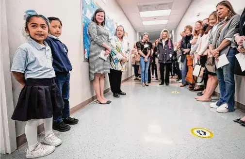  ?? Brett Coomer/Staff photograph­er ?? San Francisco Nativity Academy first graders Andrea Hernandez, left, and Emiliano Hernandez speak to members of One Hundred Shares Houston.