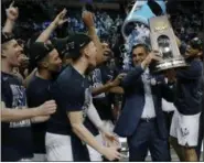  ?? CHARLES KRUPA — THE ASSOCIATED PRESS ?? Villanova’s Omari Spellman dumps confetti on Coach Jay Wright on March 25 in Boston. Villanova defeated Texas Tech, 71-59, to advance to the Final Four.