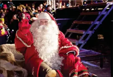  ?? LAURA HAAPAMÄKI/LEHTIKUVA/AFP ?? A man dressed as Santa Claus waves as he leaves the Santa Claus Village at the Arctic Circle in Rovaniem in Finnish Lapland on December 23, 2014.