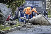  ?? LOS ANGELES TIMES ?? Cleanup crews remove a large piece of debris after a tornado with wind gusts up to 110 mph touched down in Montebello, California, for two to three minutes Wednesday.