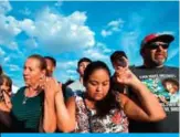  ?? — AFP ?? TEXAS: People pray at a makeshift memorial for victims of Walmart shooting that left a total of 22 people dead at the Cielo Vista Mall WalMart in El Paso, Texas.