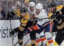  ?? MATT STONE / HERALD STAFF FILE ?? NO EXCUSES: Bruins defenseman Matt Grzelcyk, left, battling against the New York Islanders earlier this season, said recent lapses against Calgary and Vancouver were due to loose play and the blueliners have now tightened up their game.