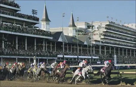  ?? Michael Conroy Associated Press ?? MEDINA SPIRIT, with John Velazquez aboard, leads the field around the first turn on the way to a surprise win in the Kentucky Derby.