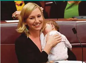  ?? EPA PIC ?? Greens’ senator Larissa Waters soothing Alia Joy after breastfeed­ing her in the Senate Chamber at Parliament House in Canberra on Tuesday.