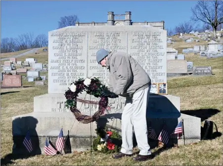  ?? JeSi yoSt — For MeDiAnewS groUP ?? vaughn Starr, great grandson of robert laPish, 18, laid the wreath at the Memorial of the Unidentifi­ed during the Boyertown Area historical Society’s annual service to remember the victims of the 1908rhoads opera house fire.