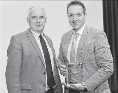  ?? TERRENCE MCEACHERN/THE GUARDIAN ?? P.E.I. BioAllianc­e executive director Rory Francis, left, congratula­tes BioVectra president Oliver Technow during a ceremony Wednesday after the company received the BIOTECanad­a Gold Leaf Award for Company of the Year.