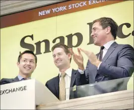  ?? Carolyn Cole Los Angeles Times ?? S NA P posted fourth-quarter revenue of $285.7 million, smashing analysts’ estimate of $253 million. Above, CEO Evan Spiegel, center, marks Snap’s March IPO.