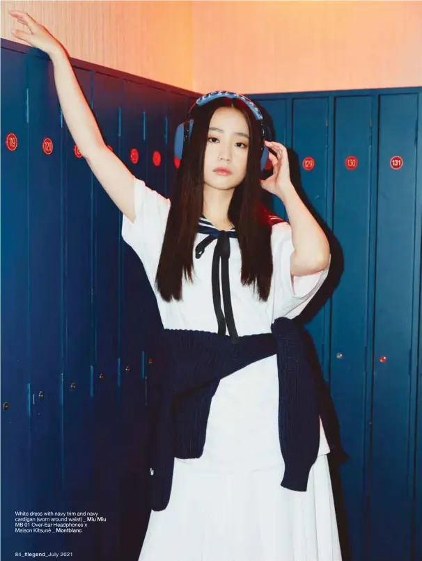  ??  ?? White dress with navy trim and navy cardigan (worn around waist) _ Miu Miu MB 01 Over-Ear Headphones x Maison Kitsuné _ Montblanc