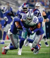  ?? ASSOCIATED PRESS ?? NEW YORK GIANTS LINEBACKER B.J. Goodson (left) and linebacker Devon Kennard (59) stop Dallas Cowboys tight end Jason Witten (82) after Witten caught a pass breaking the Cowboys all-time receiving yards held by Michael Irvin in the first half of...