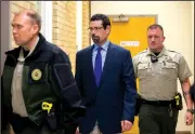  ?? NWA Democrat-Gazette/JASON IVESTER ?? Benton County Sheriff’s Office deputies accompany Brian Post (center), 48, of Springdale, as he is led Friday into the Benton County Courthouse in Bentonvill­e. Post is charged with attempted capital murder, five counts of rape and first-degree battery.