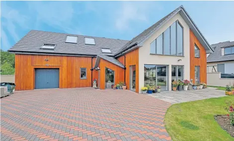  ?? ?? IMPRESSIVE: This six-bedroom family home is sleek and modern and offers views over the countrysid­e.