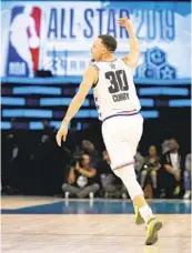  ?? CHUCK BURTON AP ?? Team Giannis’ Stephen Curry of the Warriors cheers after assisting on a basket in the NBA All-star Game.